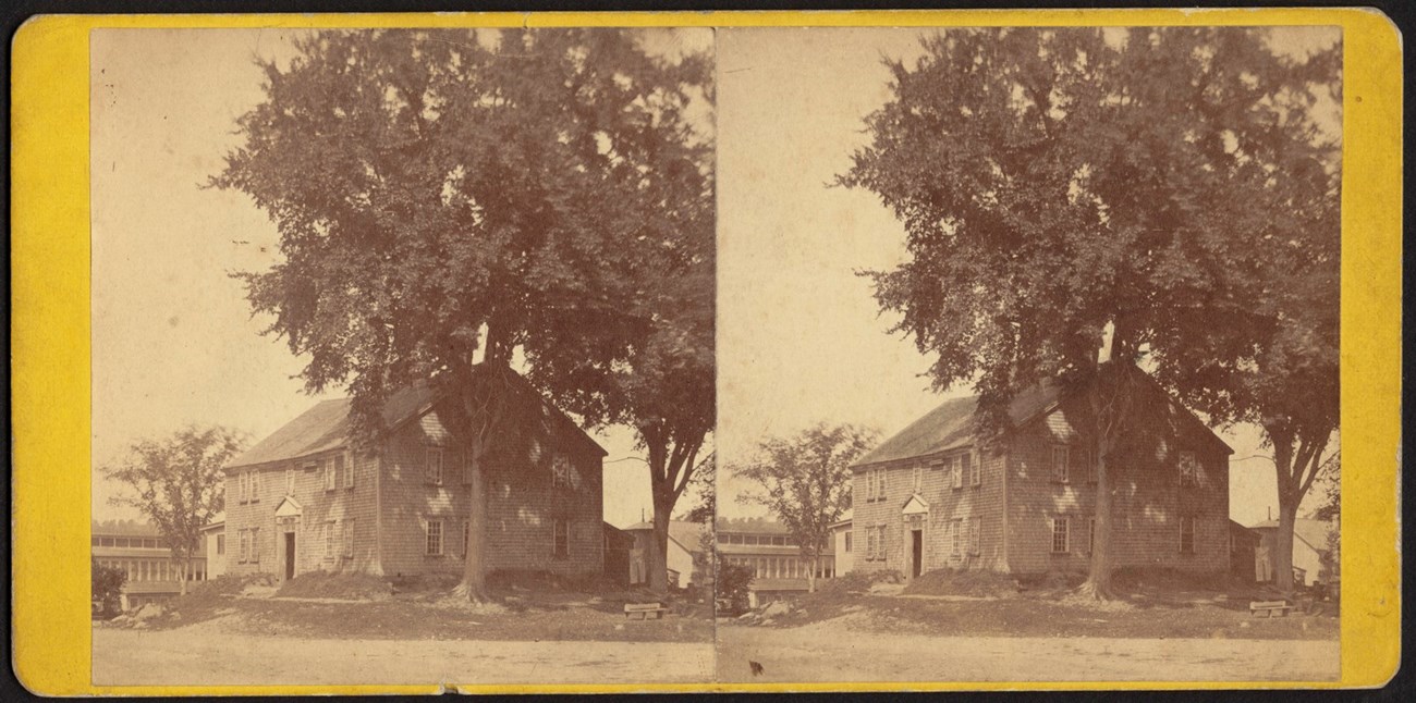 Stereoscopic view of old house in the commune. Wood frame structure with doors and windows