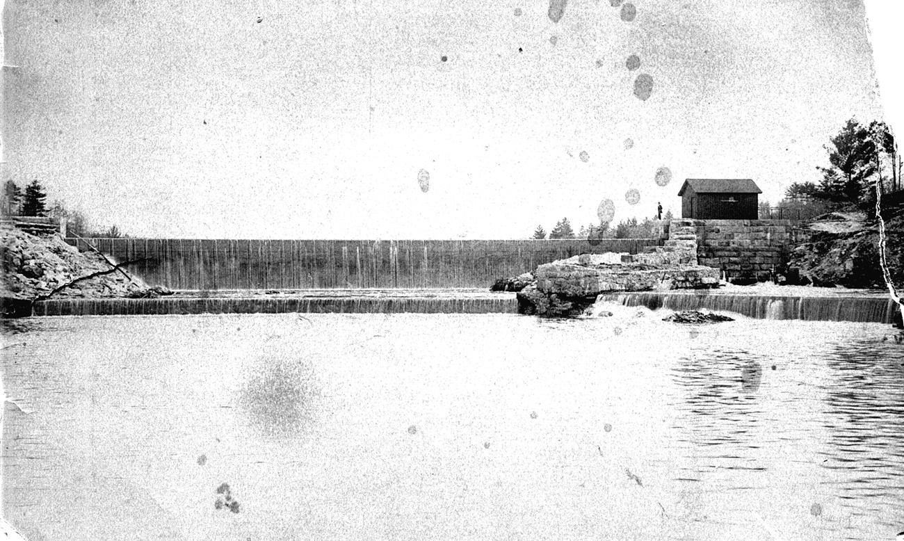 Black and white photograph of upper dam spanning the Branch River