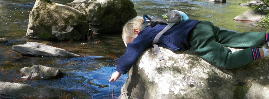 child playing by the water