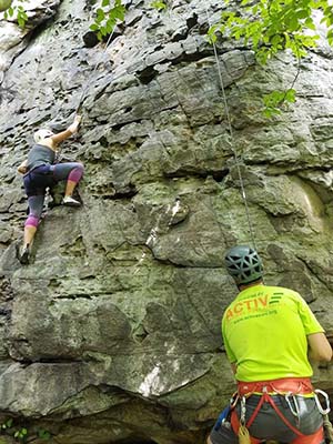 rock climber and guide climbing a cliff