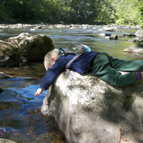 child playing with a stick in the water