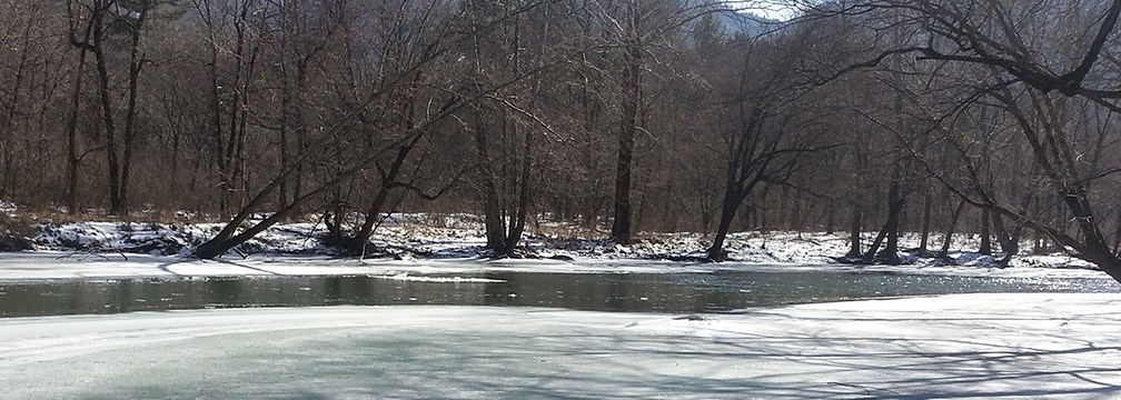 river partially frozen over with ice