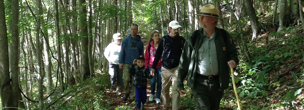 ranger leading hikers on a trail