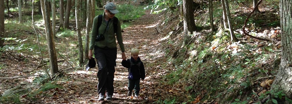 Mother and young boy hiking on a trail