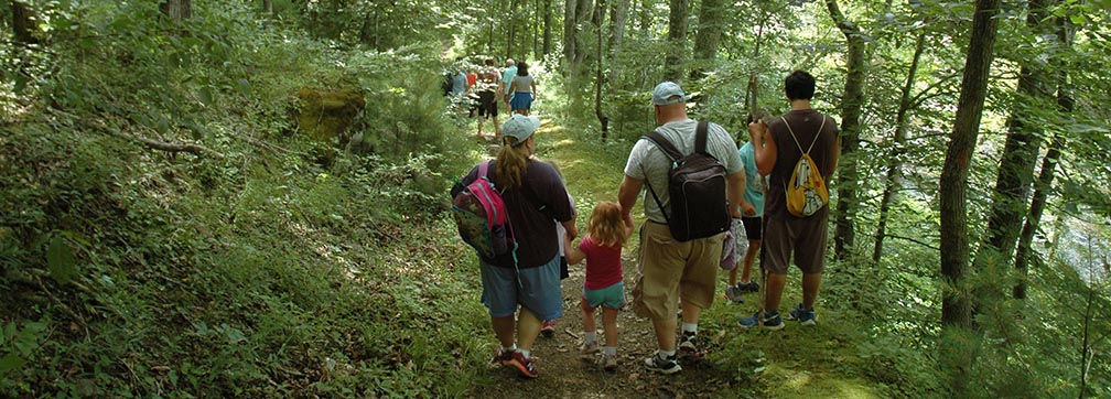 hikers on a riverside trail