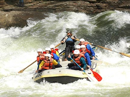 Raft navigating big whitewater