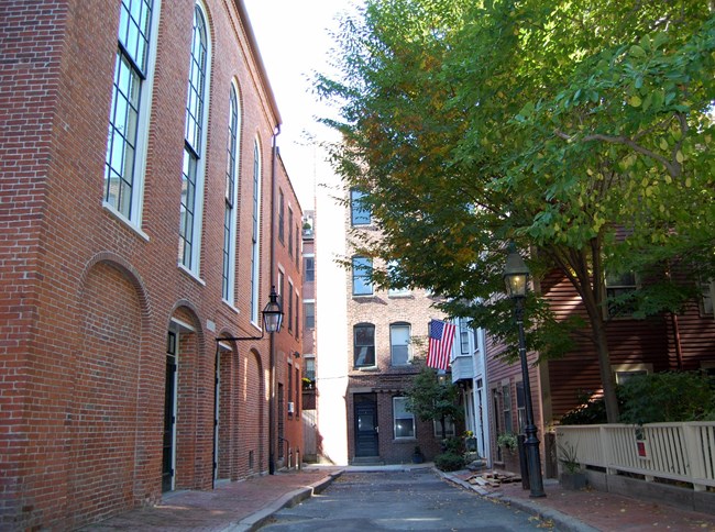 Smith Court which ends in a court surrounded by residences constructed out of brick and wood.