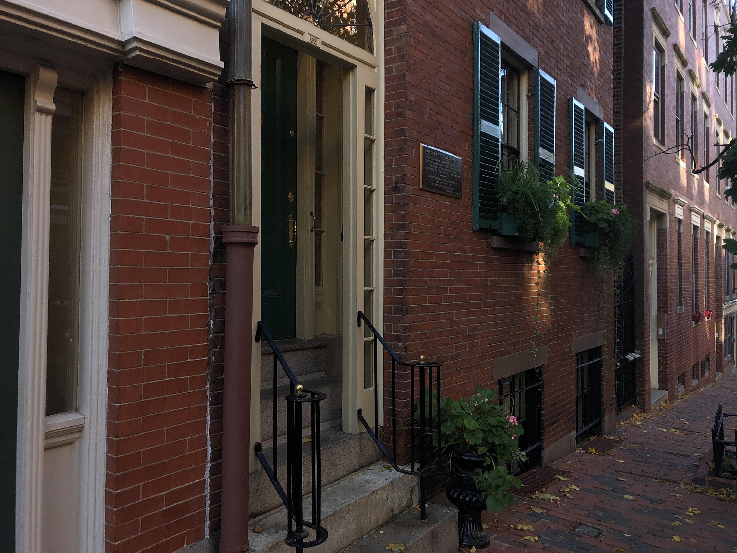 HaydenHouse-edited2 Side view of a house with green shutters and a green door in a string of Brick Houses.