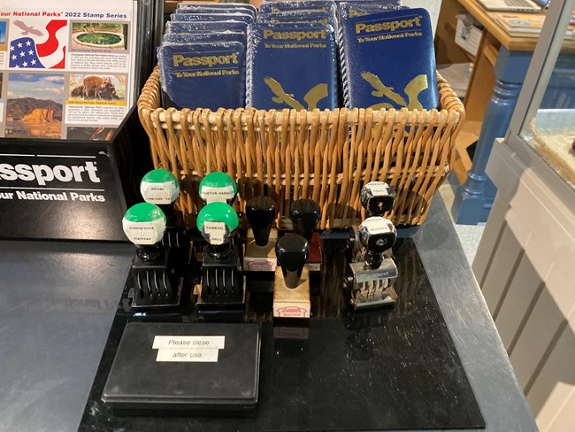 NPS Passport books and stamps on a desk.