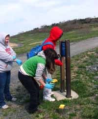 Girl Scouts refurbish wayfinding signs. Girl Scouts refurbish wayfinding signs.