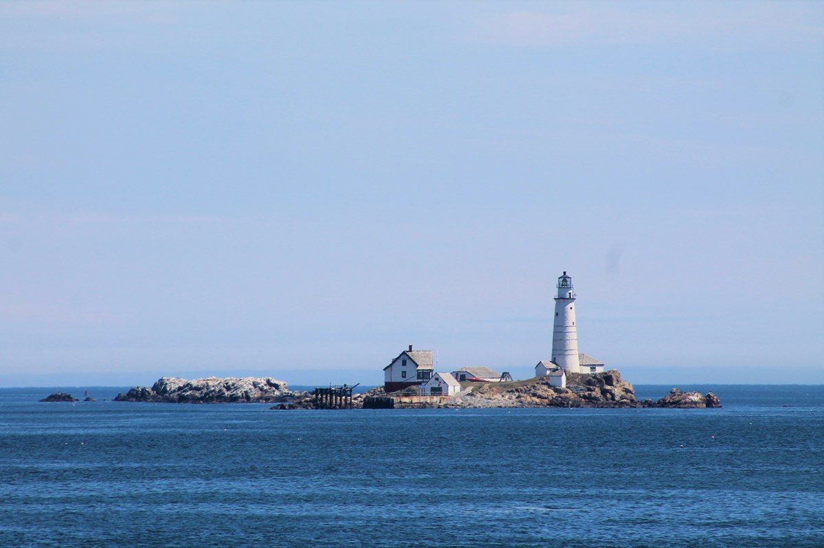 small rocky island with a white lighthouse