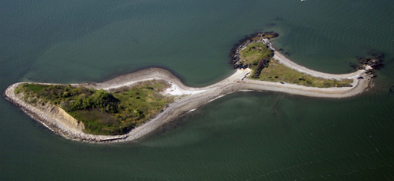 aerial shot of a small island in the shape of a music note.