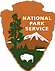 Brown arrowhead with green tree, white bison, white-capped mountain, and lake. White text reads: National Park Service.