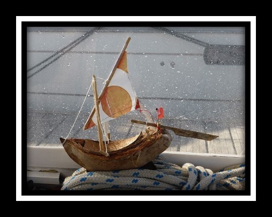A small sailboat made out of parts of a coconut.
