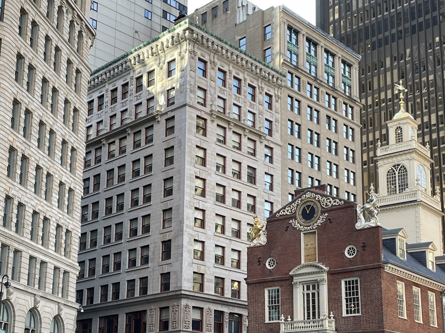 StateStreet-cropped4-3 a 11 story granite building next to a historic brick building.