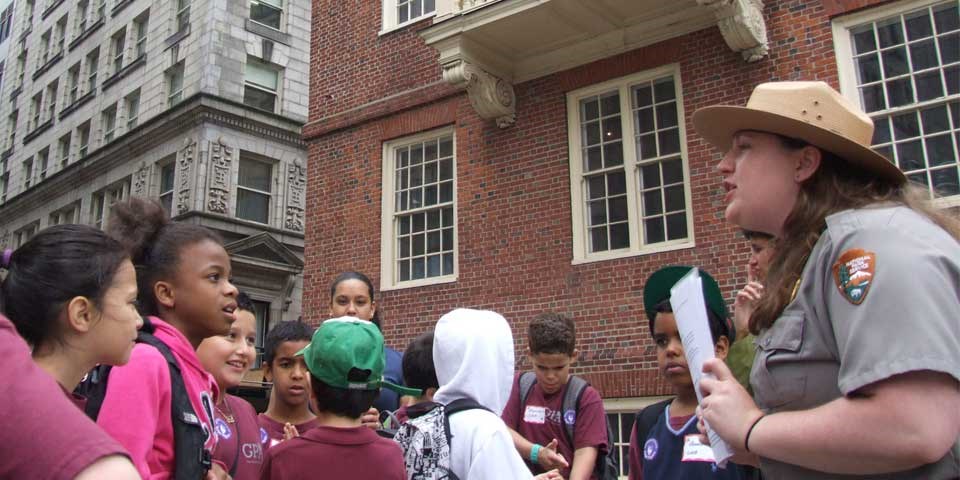A park ranger leads a tour for children outside the Old State House A park ranger leads a tour for children outside the Old State House