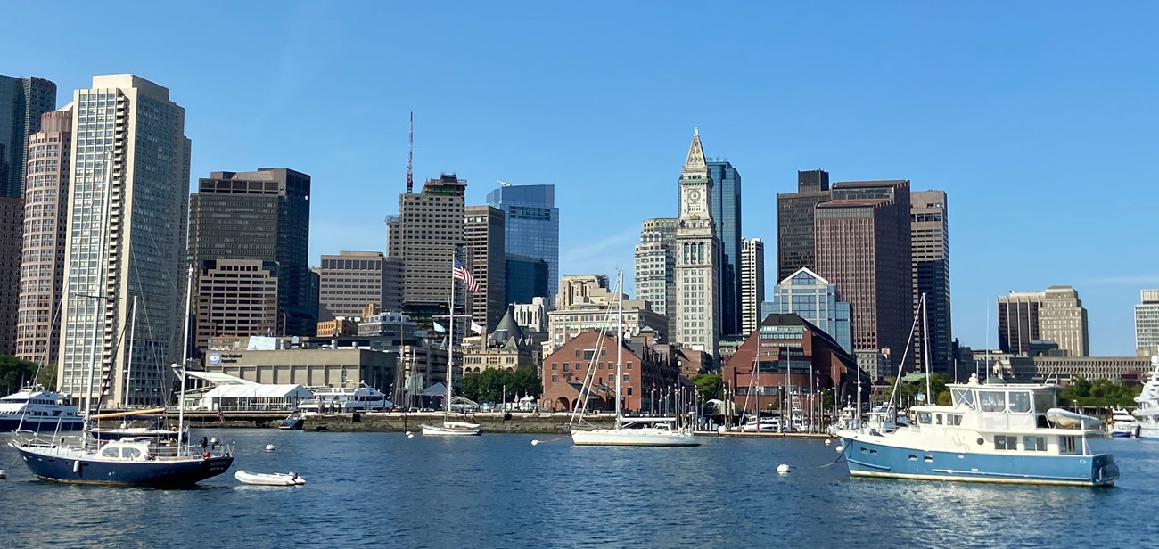 View of buildings of various sizes along the coast on a harbor.