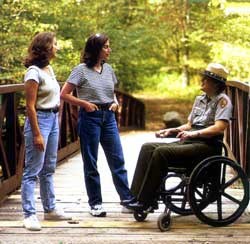 Ranger in a wheelchair talking to visitors Ranger in a wheelchair talking to visitors