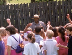 Students raising hands to answer questions.