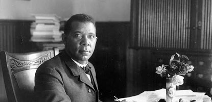 Booker T. Washington sitting at desk