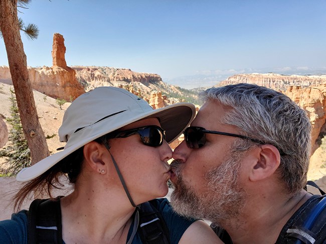 A man and a woman share a kiss