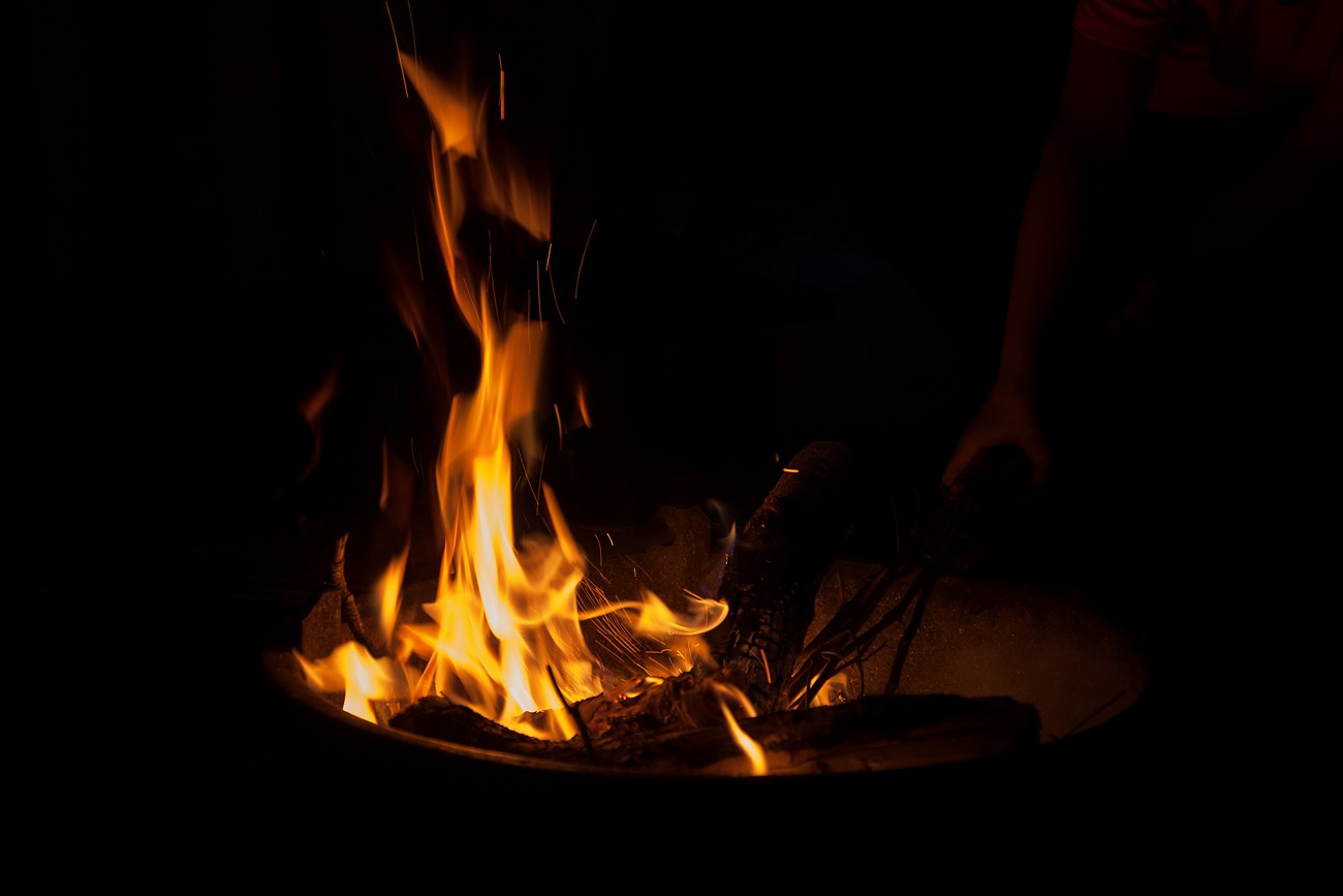 Red and orange flames glow against a black background