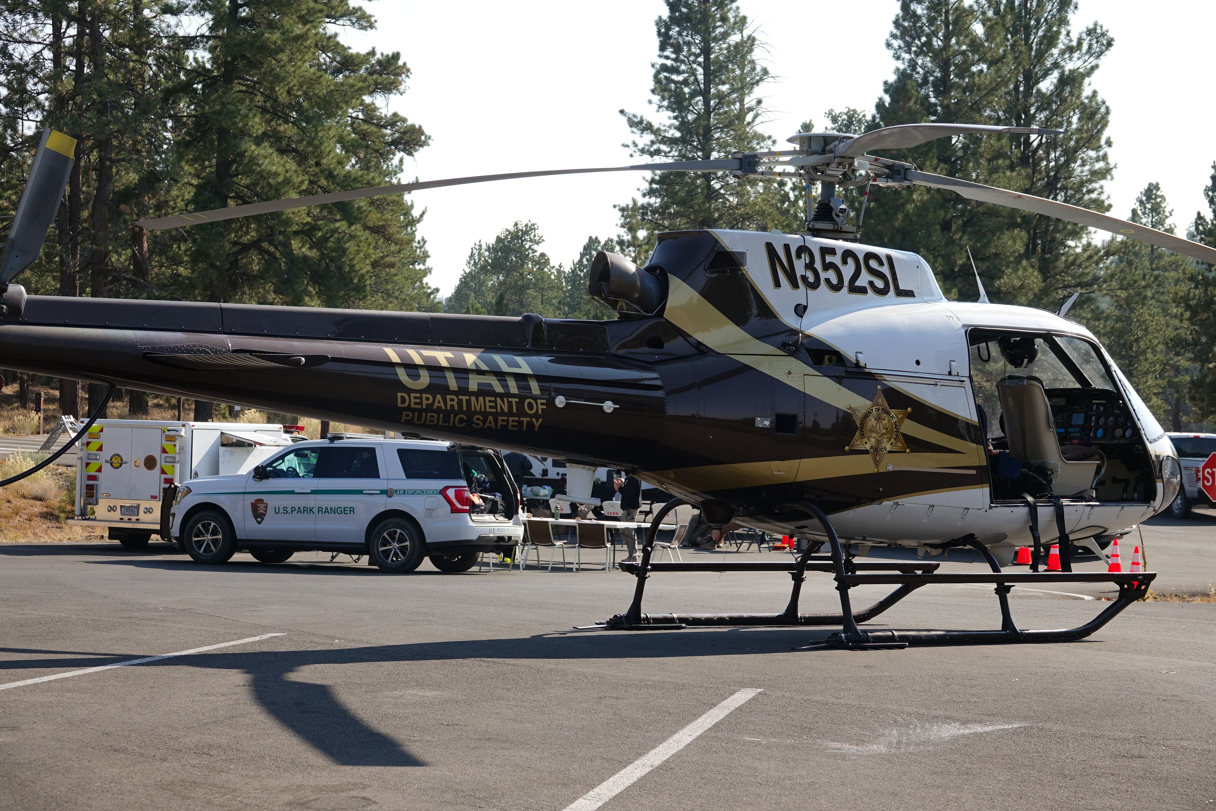 Search and Rescue Incident Command Helicopter, Park Ranger, and Search and Rescue vehicles in parking lot