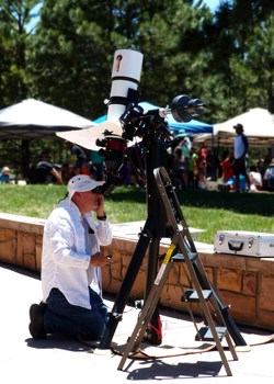 Volunteer looks through solar telescope
