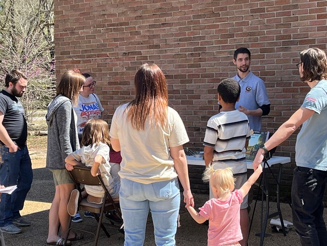 Several people stand around a volunteer.
