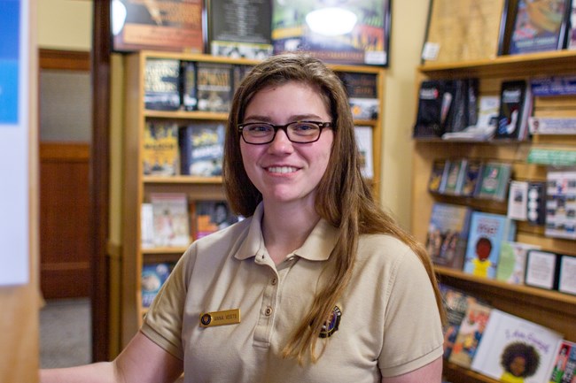 A volunteer stocks the bookstore