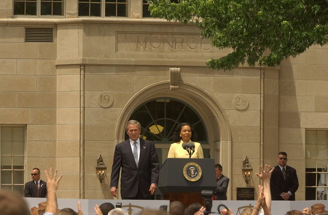 President George W. Bush and Cheryl Brown Henderson stand in front of Monroe School during the 50th Anniversary celebration of the Brown decision.