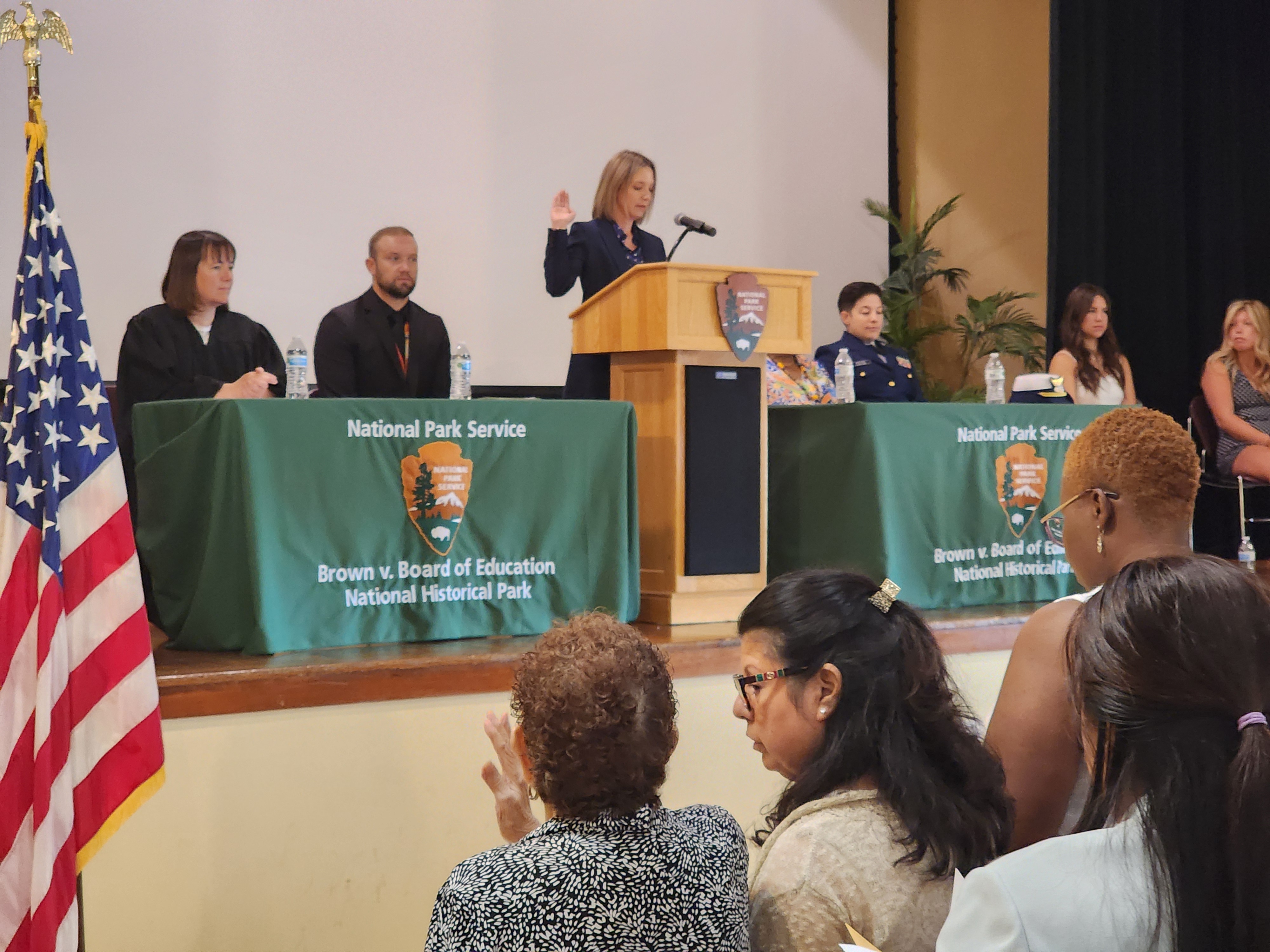 New Citizens are sworn in while surrounded by friends and family.