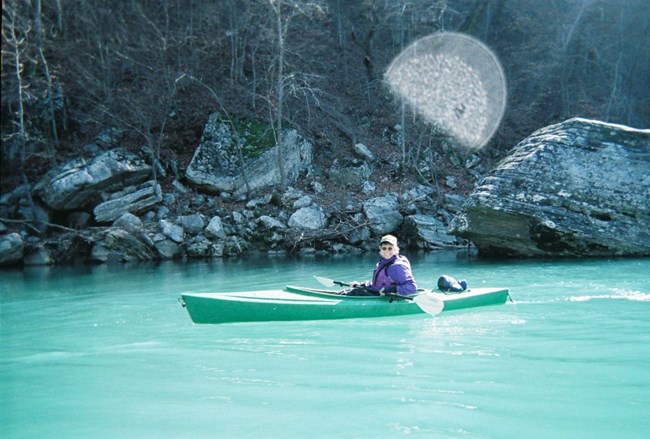 A kayaker paddles down the Buffalo River in winter.