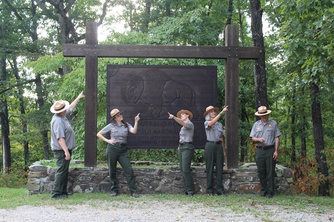 5 park rangers comically point in different directions