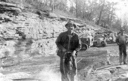 man operating air hammer in stone quarry