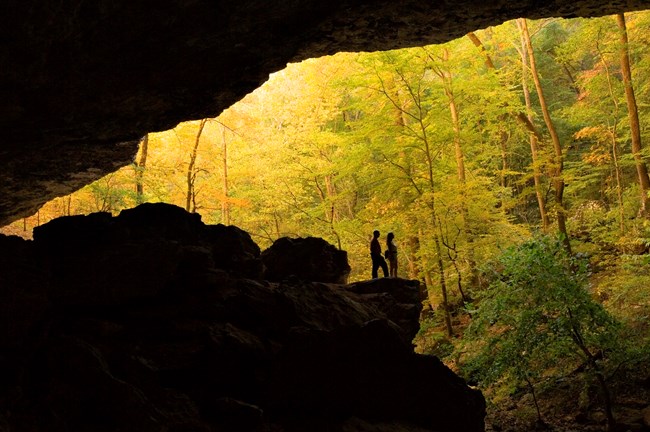 Silhouettes of hikers outside of Cobb Cave at Lost Valley