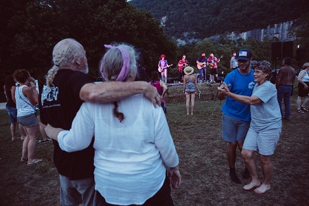 Musicians play with the Steel Creek bluffs as background