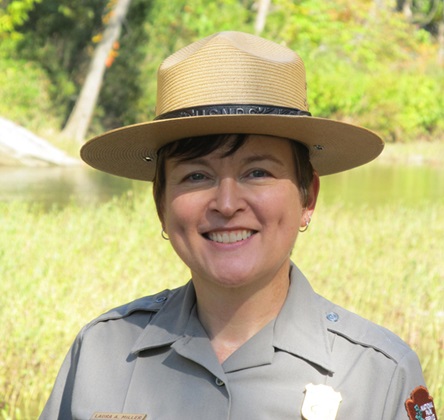 Portrait of Superintendent Laura Miller outdoors in a National Park Service uniform.