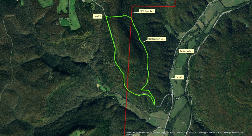 satellite image with bright green line showing fire containment line