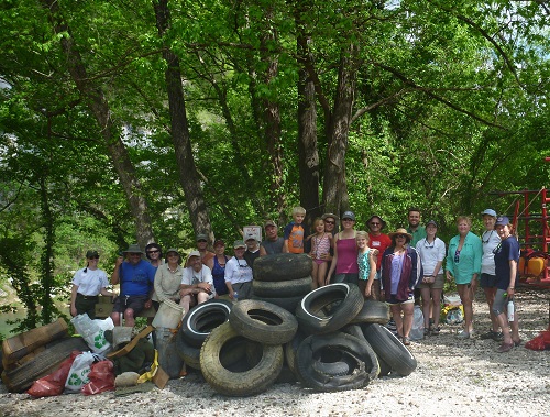 Staff and volunteers with the pile of tires from the river cleanup.