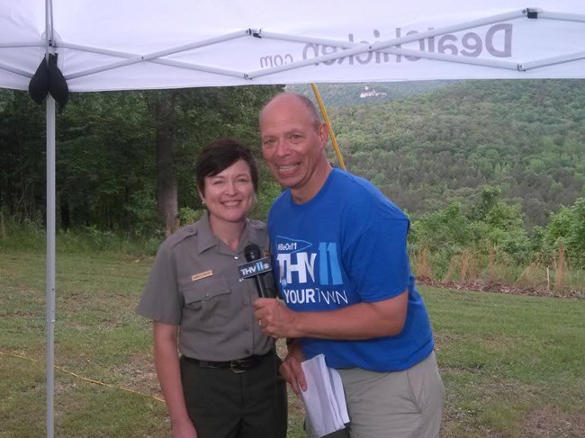 A reporter interviews a park ranger.