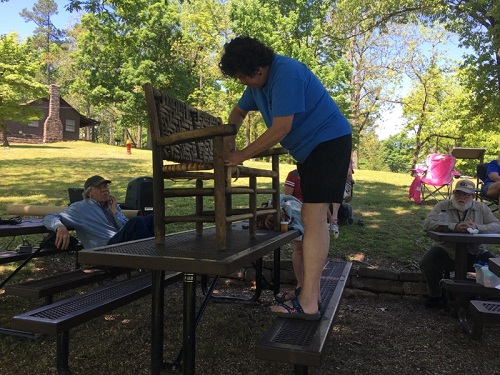 volunteer weaving new seat for old setee