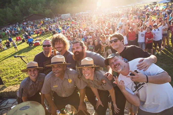 two rows of people, band members in back with park employees in front