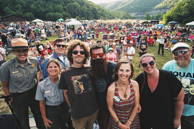 NPR band, staff, BNRP president and concert goers 2018 color photo of large growd of people in background and band members and staff in foreground