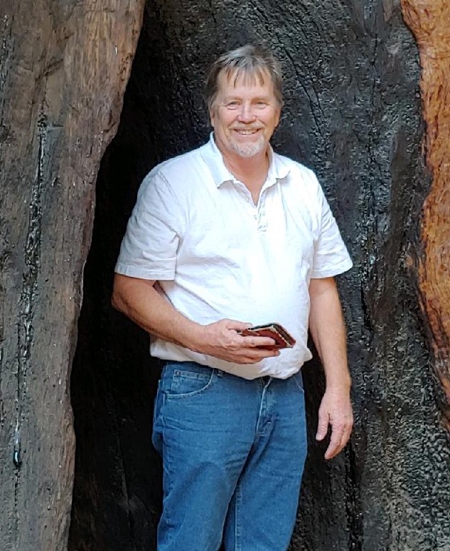Missing hiker Clinton Preston Smith Color photograph of a smiling grey-haired man wearing a white shirt and blue jeans.