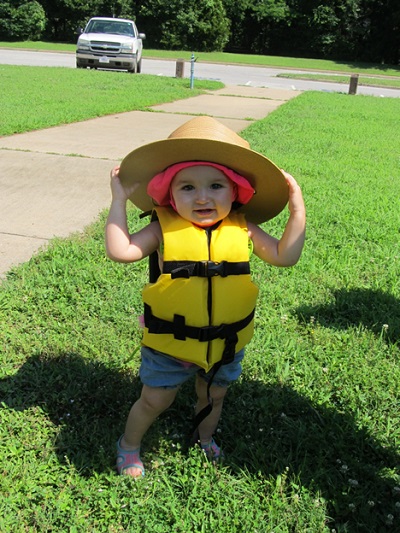 little girl wearing life jacket and ranger flat hat