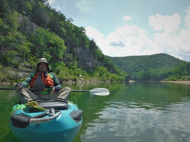 jerry goller camphost photo of man in kayak at left with river at center and right
