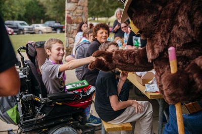 Smokey Bear shakes hands with Special Olympian