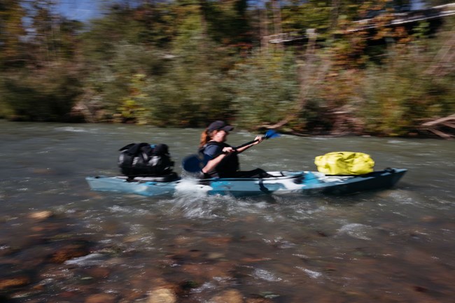 A kayaker paddles downstream from Ponca