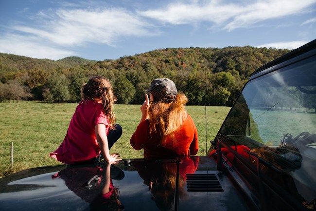 A family watches for wildlife along the roadside in Boxley Valley